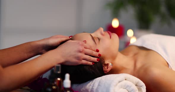 Female Hands Doing Head Massage to Woman Client in Spa Salon  Movie Slow Motion