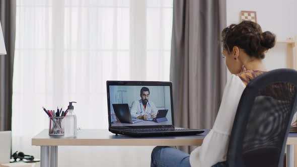 Woman in a Remote Video Call with Her Doctor