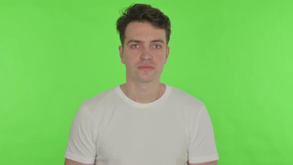 Disappointed Young Man Reacting Loss on Green Background