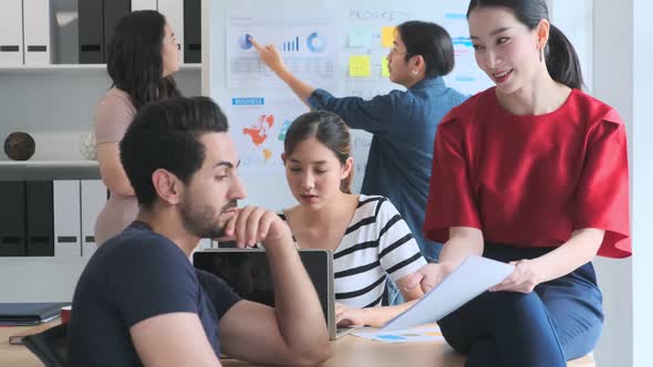 Group of asian young creative happy people casual dress entrepreneur on a Team discussing