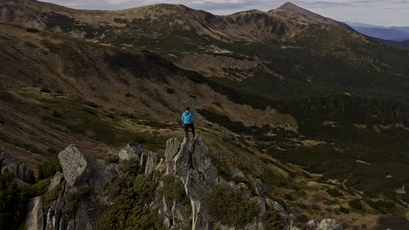 Traveler Climb on Mountain Rock Top Aerial