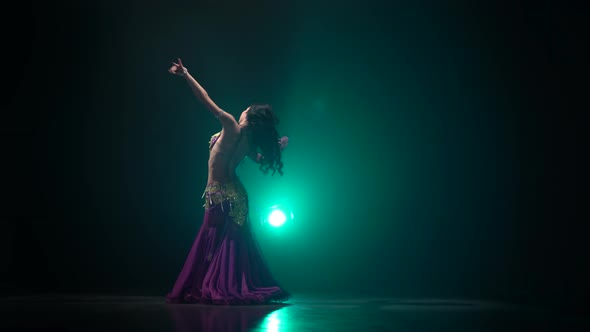 Brunette Dances Belly Dancing. Smoke Background