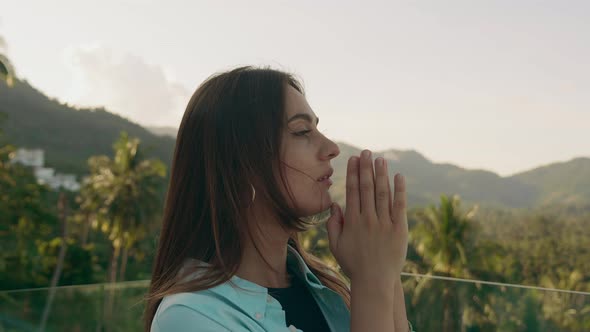 Contemplative Young Woman Looking Up to Sky with Faith and Hope