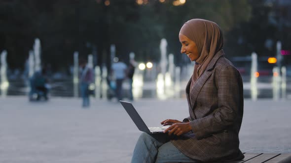 Side View Muslim Islamic Girl Arabic Business Woman Student Teacher Freelancer Sitting in Evening