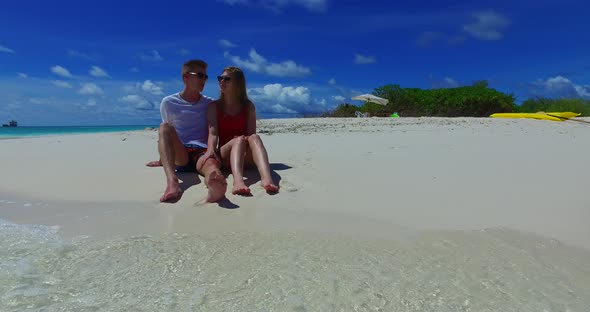 Beautiful people on romantic honeymoon have fun on beach on summer white sandy background 