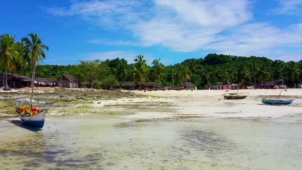 beach scene with dhow fishing boats and white sand in Madagascar