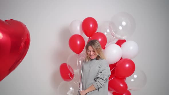 an Blonde Woman Dances and Has Fun with Balloons Valentine's Day