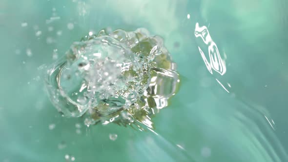 Super Slow Motion of Falling Half Lime Into Splashing Water