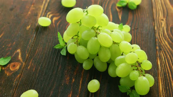 Grapes on Branch on Dark Table 