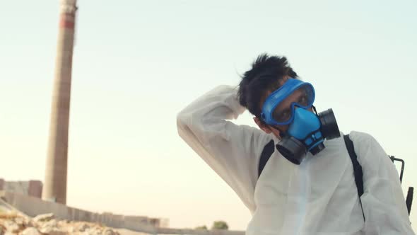 Man Taking off Safety Goggles and Mask