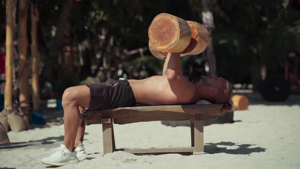 Man Training on the Beach in Eco Gym