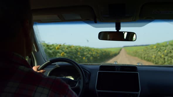 Farmer Driving Countryside Road Rear View