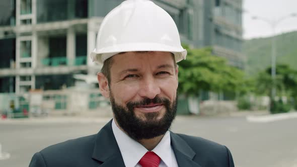 Potrait Happy Senior Engineer Planning Manufacture Work in a Business Suit in a White Protective