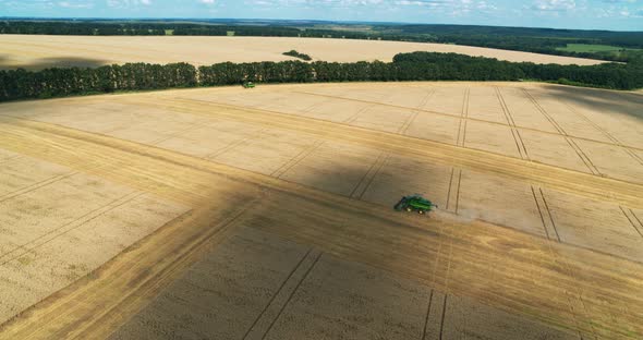 Harvester Machine Working in Field Aerial View