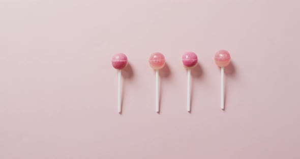 Video of pink lollipops on pink background