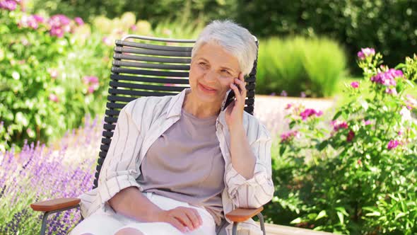 Happy Senior Woman Calling on Phone at Garden