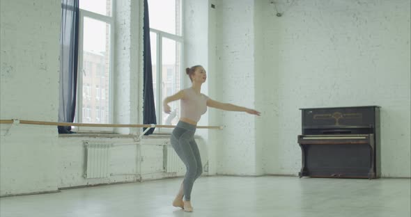 Ballerina Practicing Pirouette in Dance Studio
