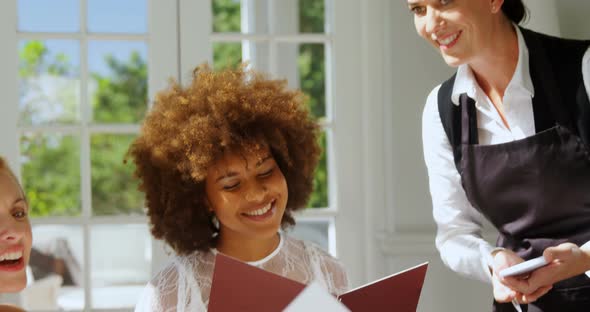 Friends placing order to waitress