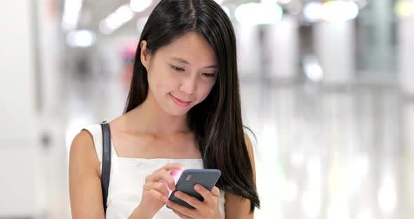 Woman use of mobile phone in the station