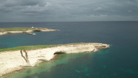 AERIAL: Storm is Coming Over Mediterranean Sea to Ta Kalanka Sea Cave Bay