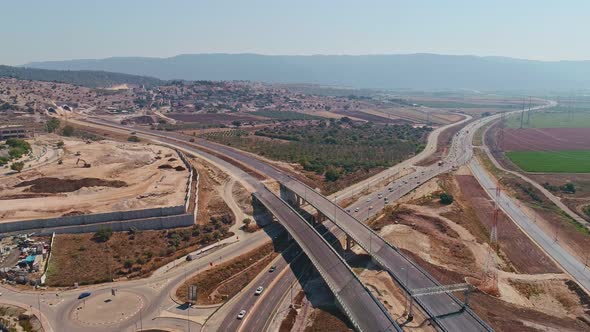 Aerial footage of large highway construction project with tunnels and bridges