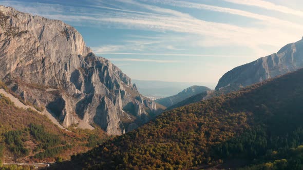 Drone flight over autumn rocky mountain in the morning light