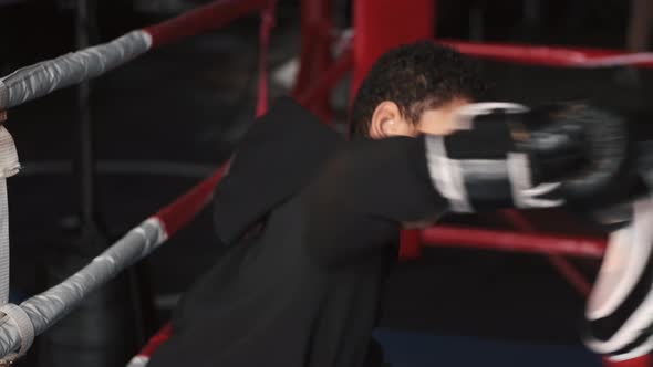 Boy Boxer Practicing Punches with His Coach at Gym