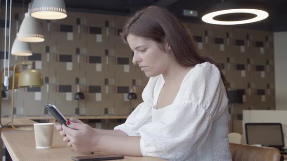 Focused Beautiful Young Woman Using Tablet