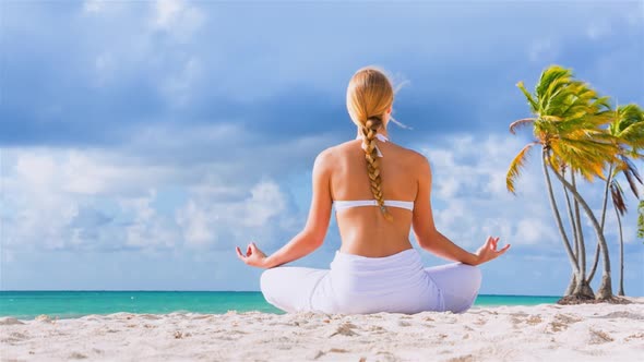 Woman meditating on beach