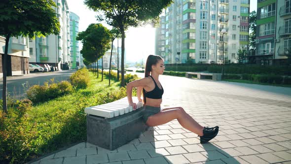 Woman Practicing Exercise on Triceps on Bench.