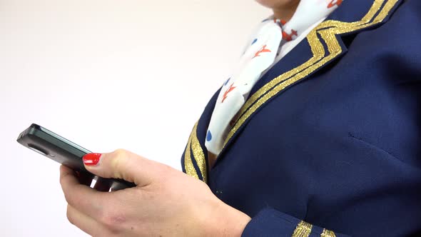 A Stewardess Works on a Smartphone - Closeup on the Hands From the Side - White Screen Studio