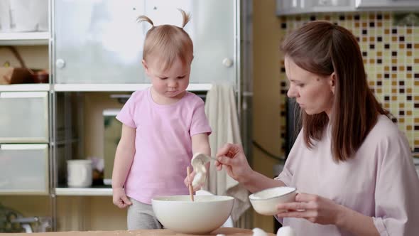 Little Cute Funny Girl Helping Mother Prepare Pie Cake in Kitchen Baking Homemade Cookie Together