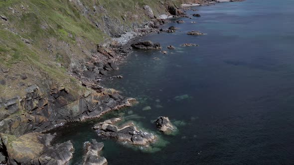 The rugged castline of southern Cornwall, England in the Poltesco area ahowing cliffs and farm land.