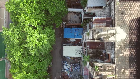 Aerial view above of a abandoned housing complex full of trash, Cambodia.