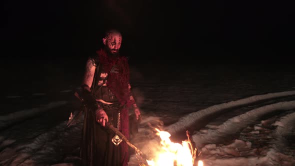 Viking with a Torch Lights Bonfire