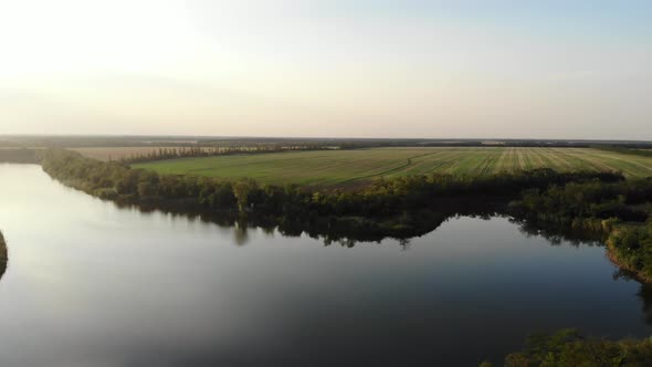 Top view of the river and field in village in summer day.