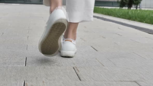 Close Up of Back View of Walking Female Legs on Street