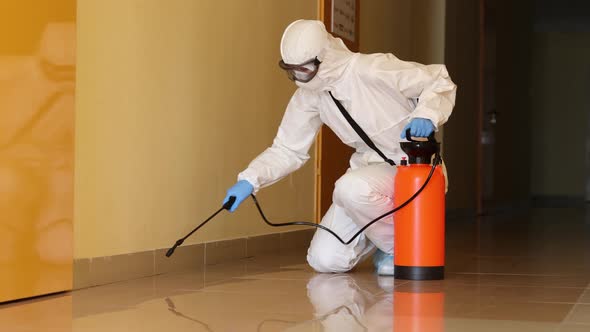 Person in Protective Suit Mask and Goggles Disinfects Corridors Indoors  Movie
