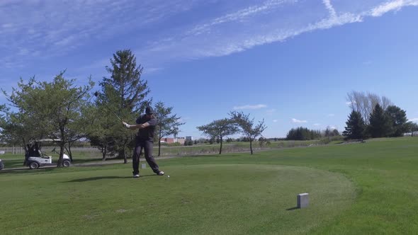 golf player driving the ball from the tee 4k approaching view