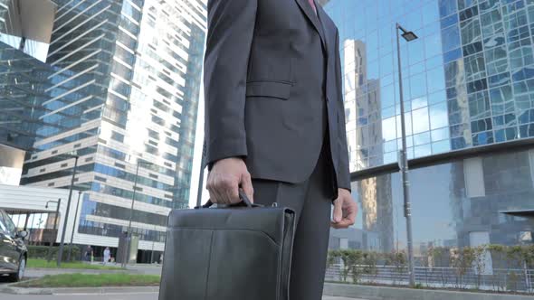 Middle Aged Businessman Standing Outside Office