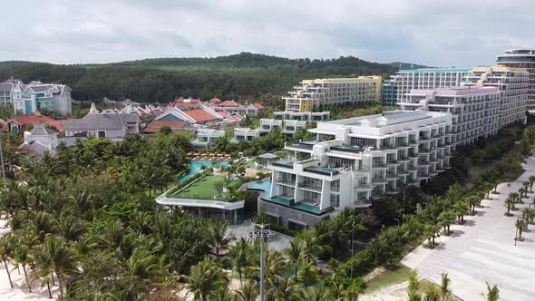 Aerial View of the Luxury Blue Ocean Hotel on an Island with White Sand Palm Trees Along the Beach