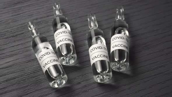 Medical ampoules with coronavirus vaccine close-up in the laboratory