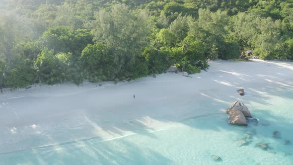 Aerial view of a person walking on the beach of Anse Lazio, Seychelles.