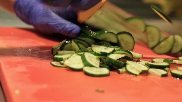 Hands of Woman Chopping Cucumber on Kitchen