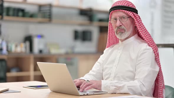 Senior Old Arab Businessman with Laptop Showing Thumbs Down