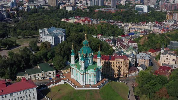 Beautiful flight over St. Andrew's Church in Kiev. Top view of Podol. Many buildings and churches.