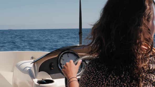Beautiful Attractive Sailor Girl Driving a Rent Small Boat Yacht