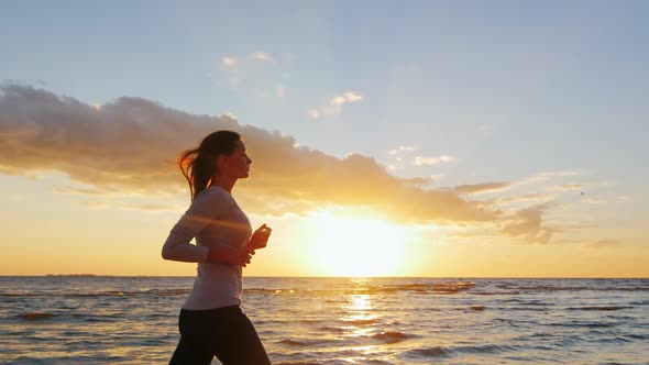 Young Attractive Woman Jogging By the Sea