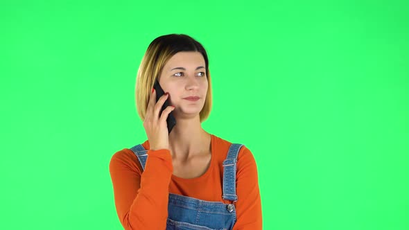 Woman Speaking Via Telephone Looking Boredon. Green Screen