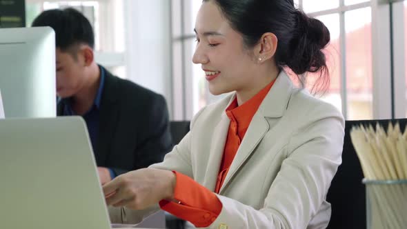 Two Business People Talk Project Strategy at Office